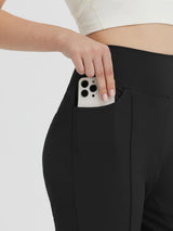 Black women's high-waisted capris with a functional side pocket holding a smartphone. #color_Black
