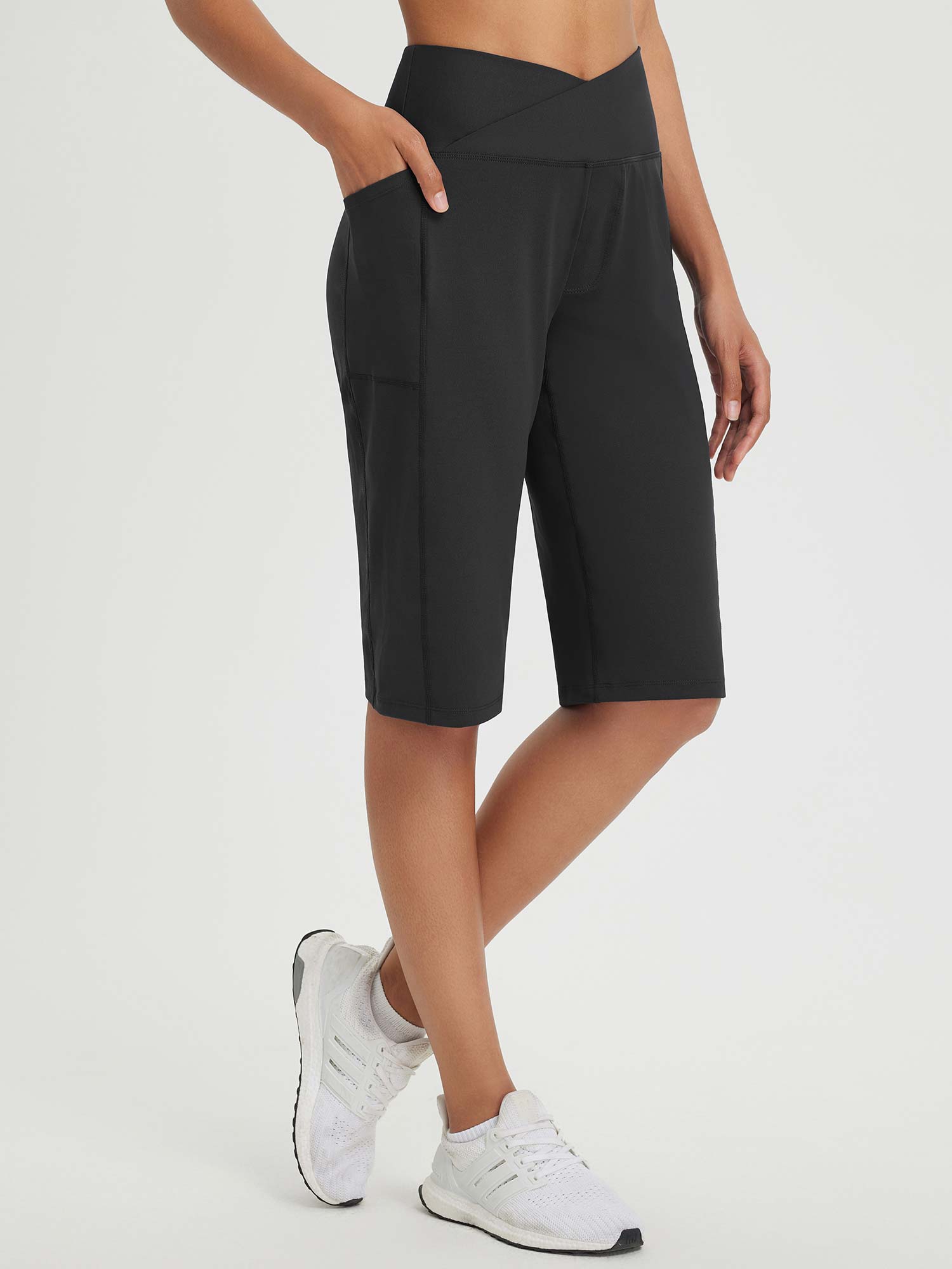 Black 14" high-rise Bermuda shorts with pockets and criss-cross waistband. #color_Black