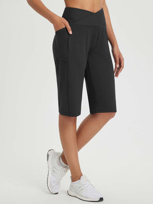 Black 14" high-rise Bermuda shorts with pockets and criss-cross waistband. #color_Black