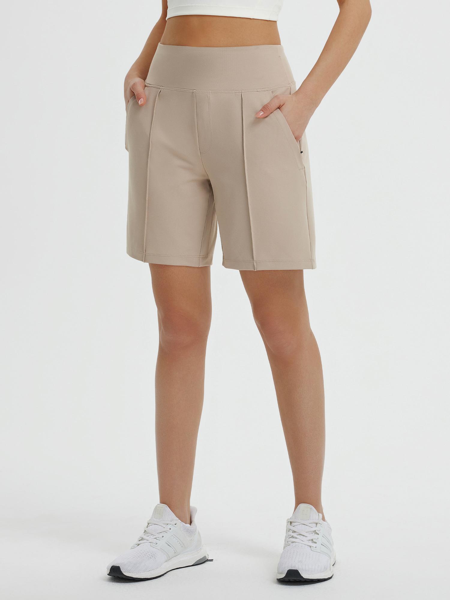 Women's 7" Bermuda long shorts in khaki with elastic waistband and pockets, paired with white sneakers. #color_Khaki