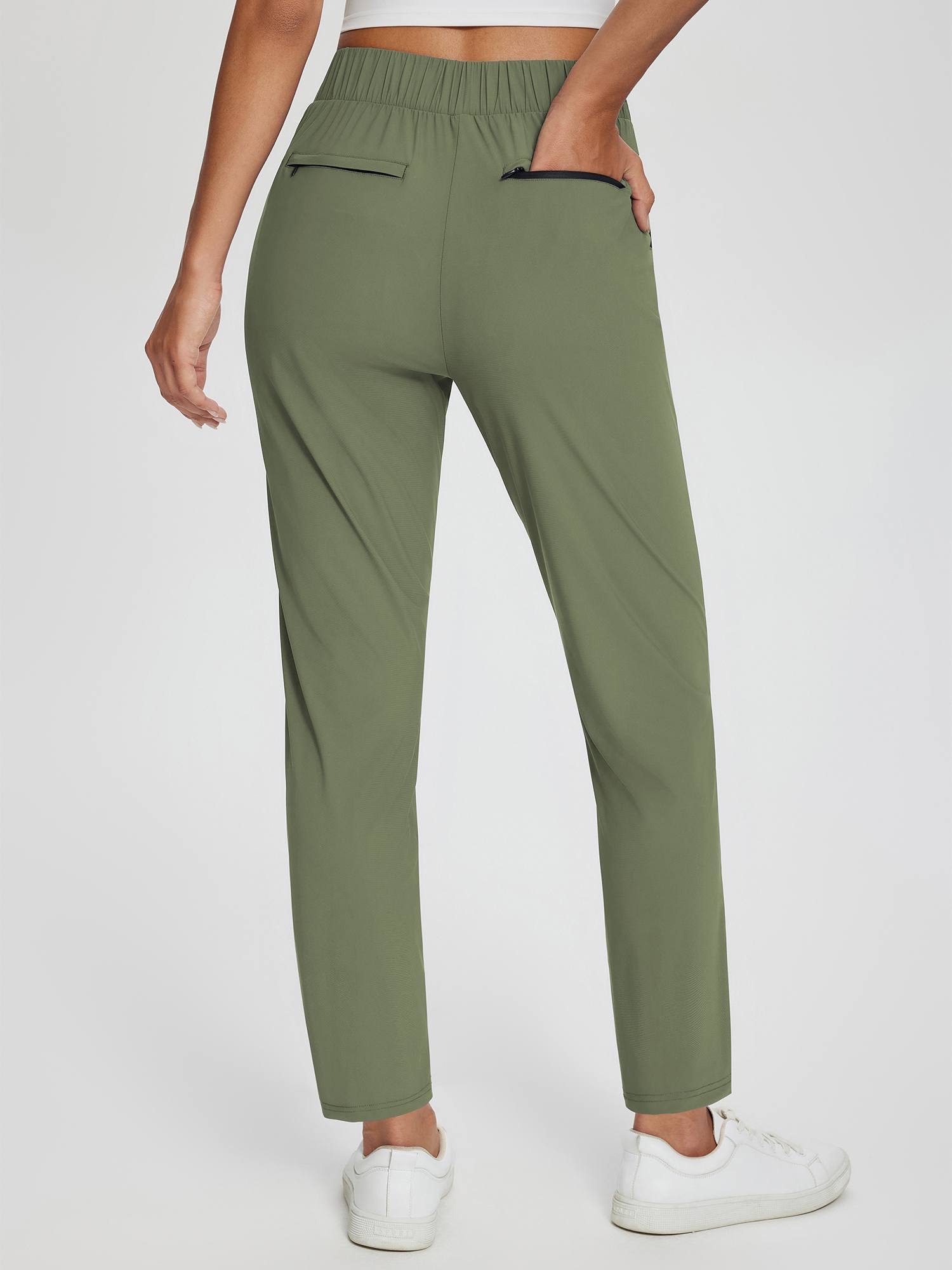 Sculpt High-Waist Tapered Yoga Pants in olive green, showing back pockets and split hem. #color_Army Green