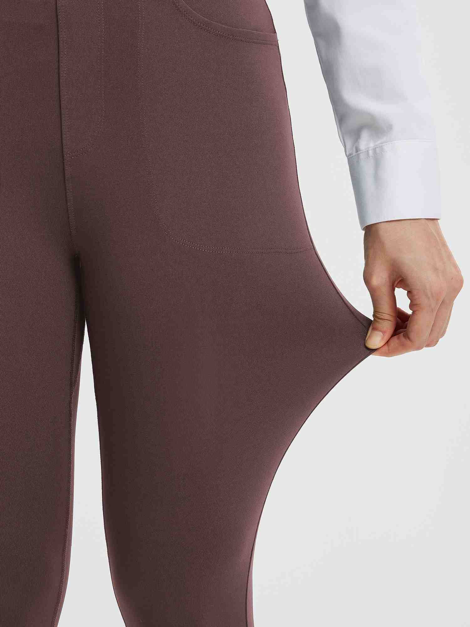 Stretch fabric detail of women's brown high-waisted yoga business pants.