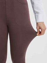 Stretch fabric detail of women's brown high-waisted yoga business pants.