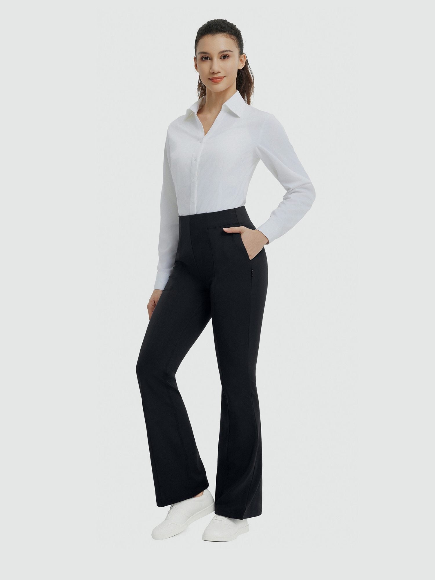 Woman models black high-waisted flared business yoga pants. #Color_Black