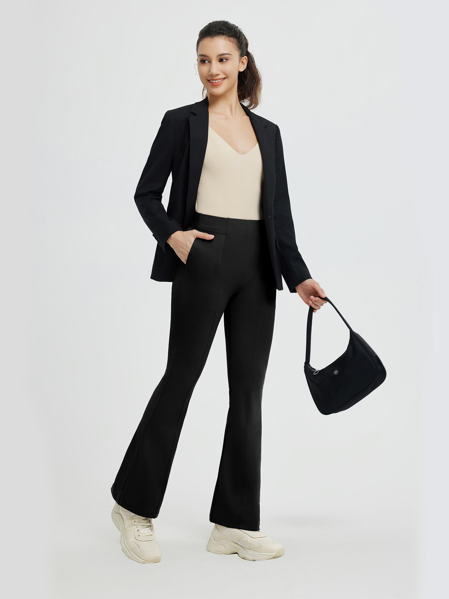 Women's black high-waisted flared yoga business pants styled with blazer. #Color_Black
