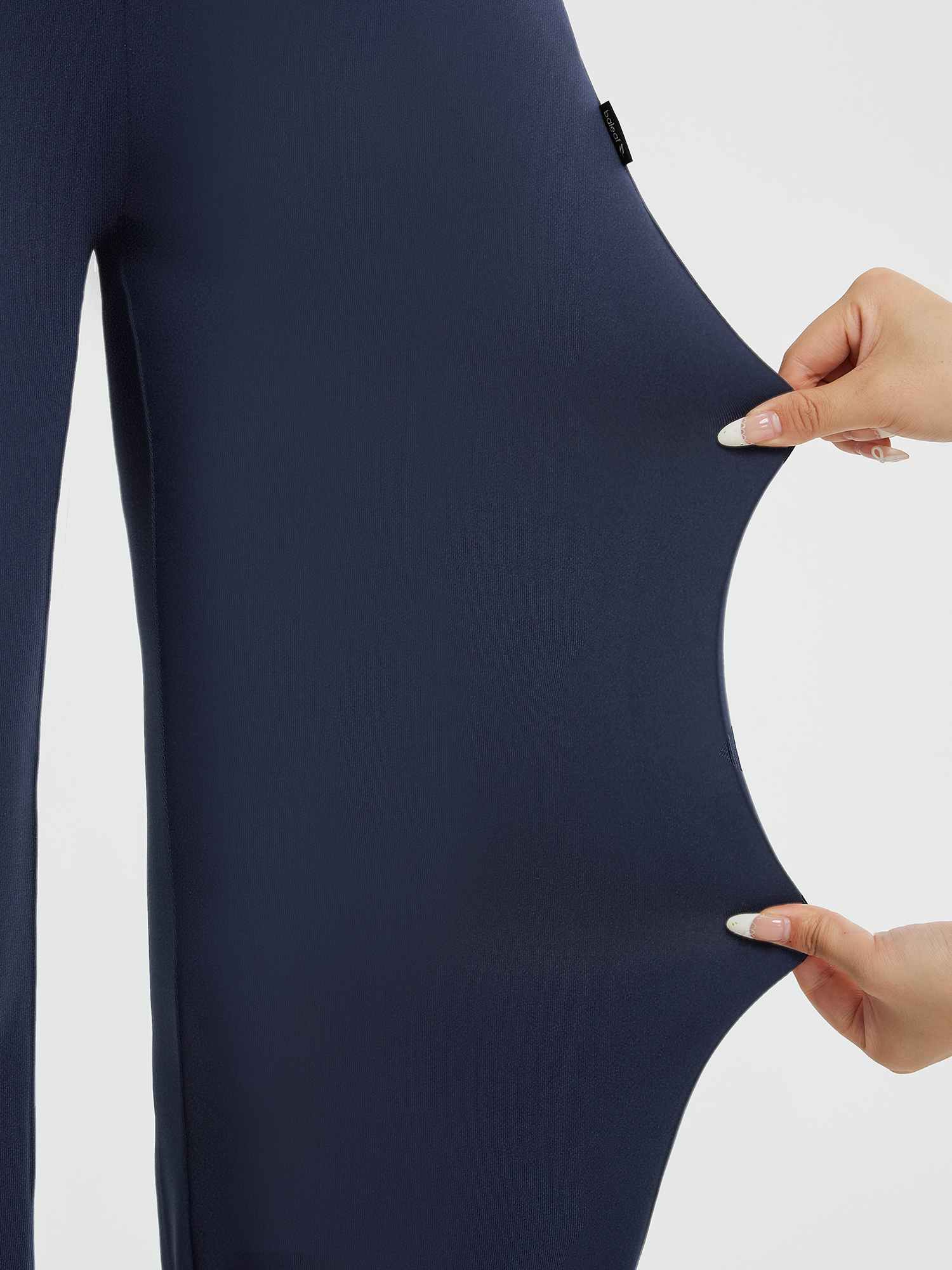 Stretch fabric detail on navy blue Yoga Commuter high-waisted wide-leg pants. #Color_Navy Blue