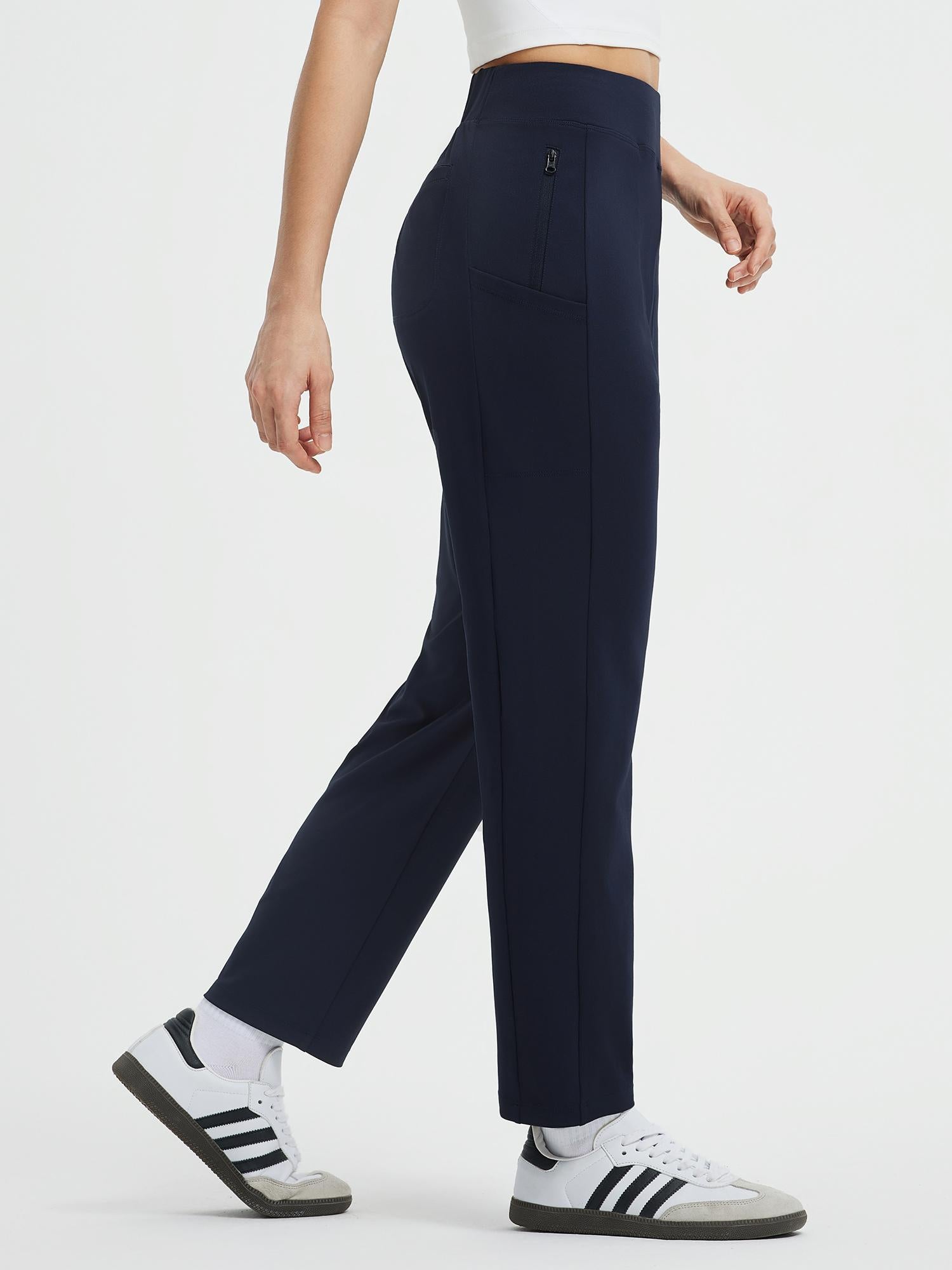 Navy blue high-waisted tapered yoga pants with zippered thigh pocket. #color_Navy Blue