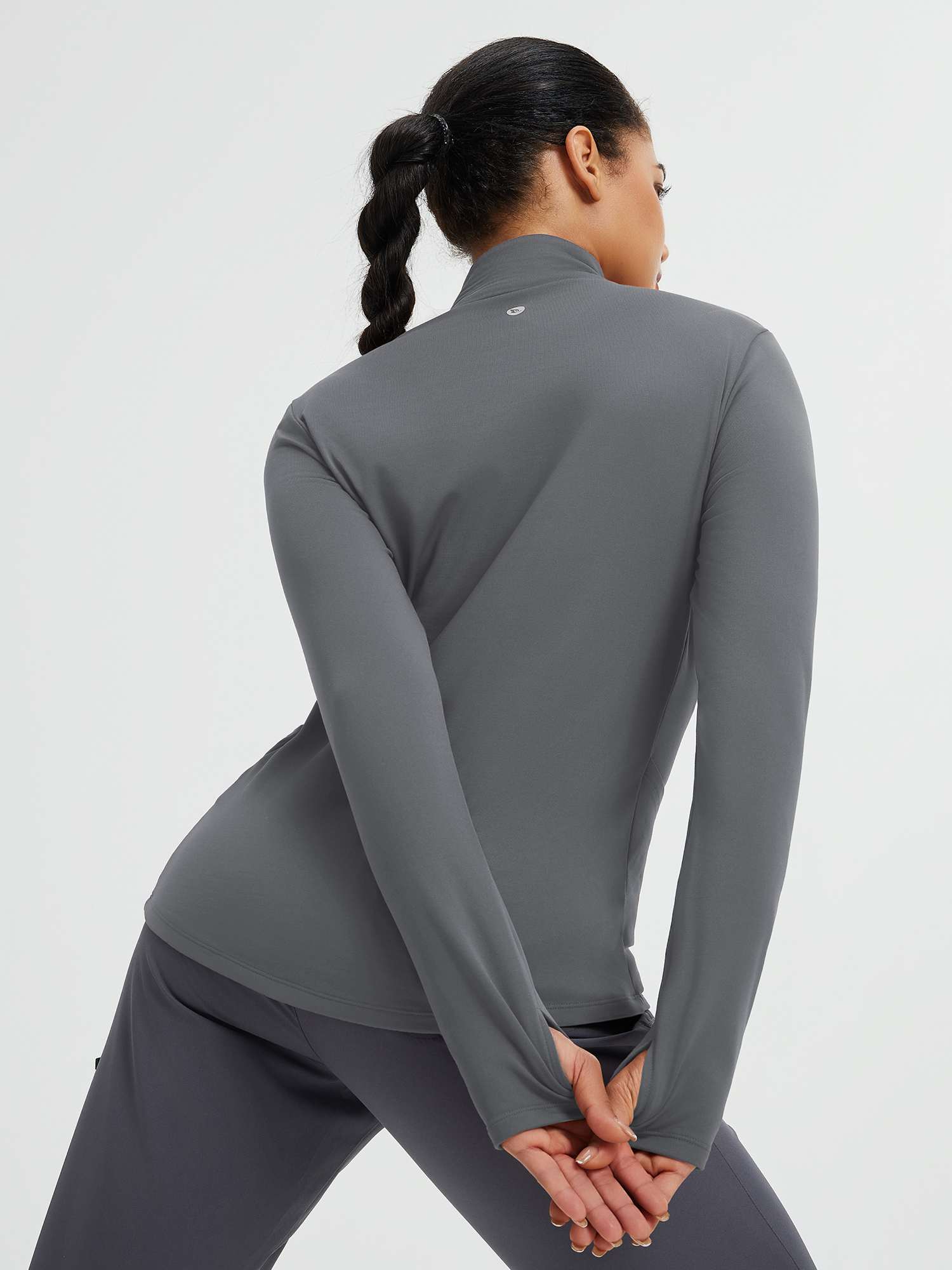 Women's grey fleece-lined yoga top with thumbholes and stand collar
