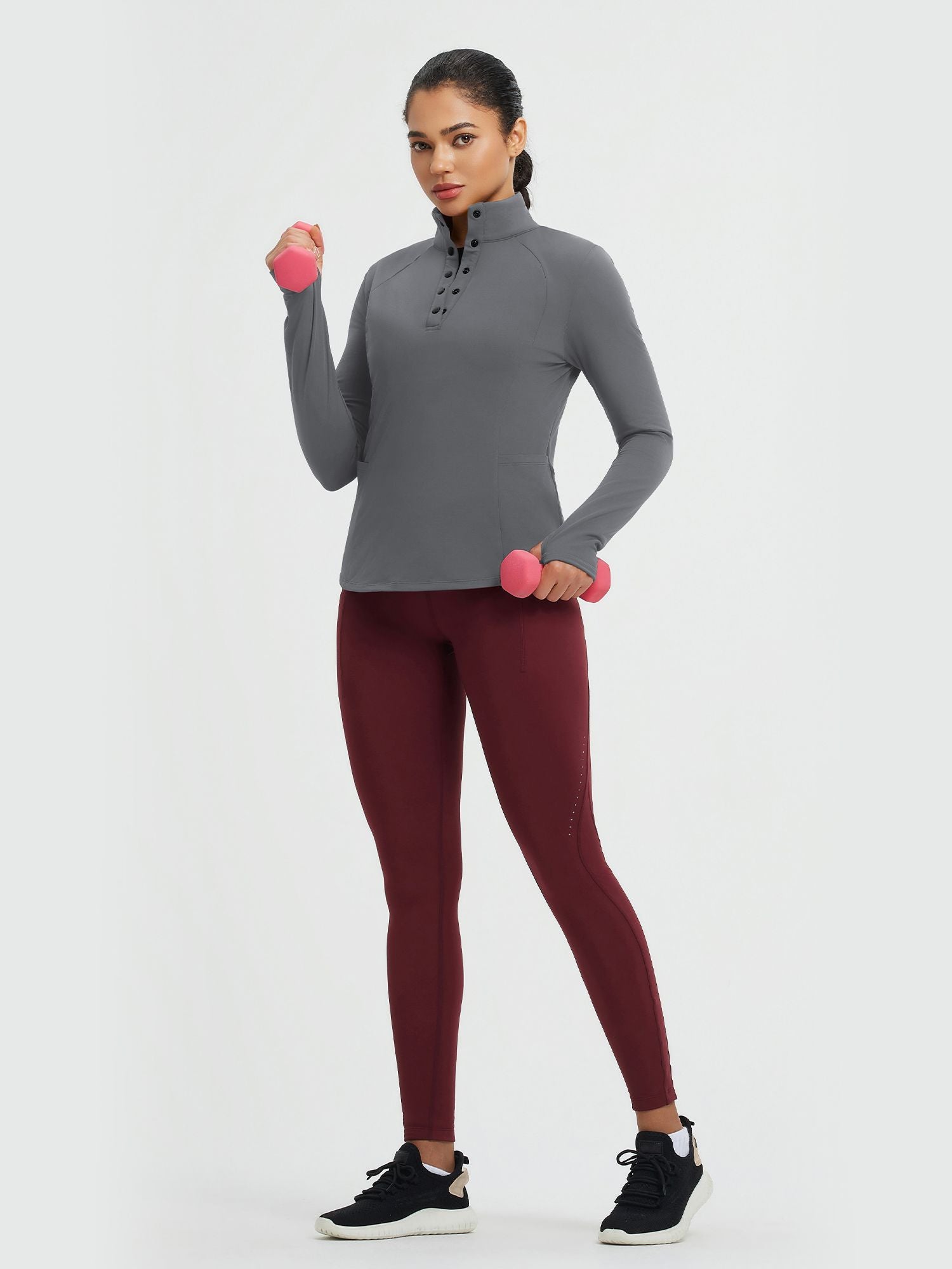 Women's grey fleece-lined half-snap yoga top, long sleeve, holding dumbbells #color_Dark Gray