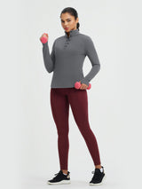 Women's grey fleece-lined half-snap yoga top, long sleeve, holding dumbbells #color_Dark Gray
