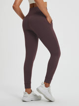 Women's plum high-waisted yoga leggings with side pockets and cuffed ankles. #color_Dark Brown