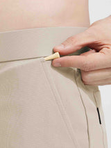 Baleaf light beige golf shorts with elastic waistband and textured fabric, hand holding golf tee. #color_Khaki