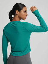 Teal Baleaf UPF 50+ long-sleeve crop sun shirt. Slim athletic fit with curved hem.