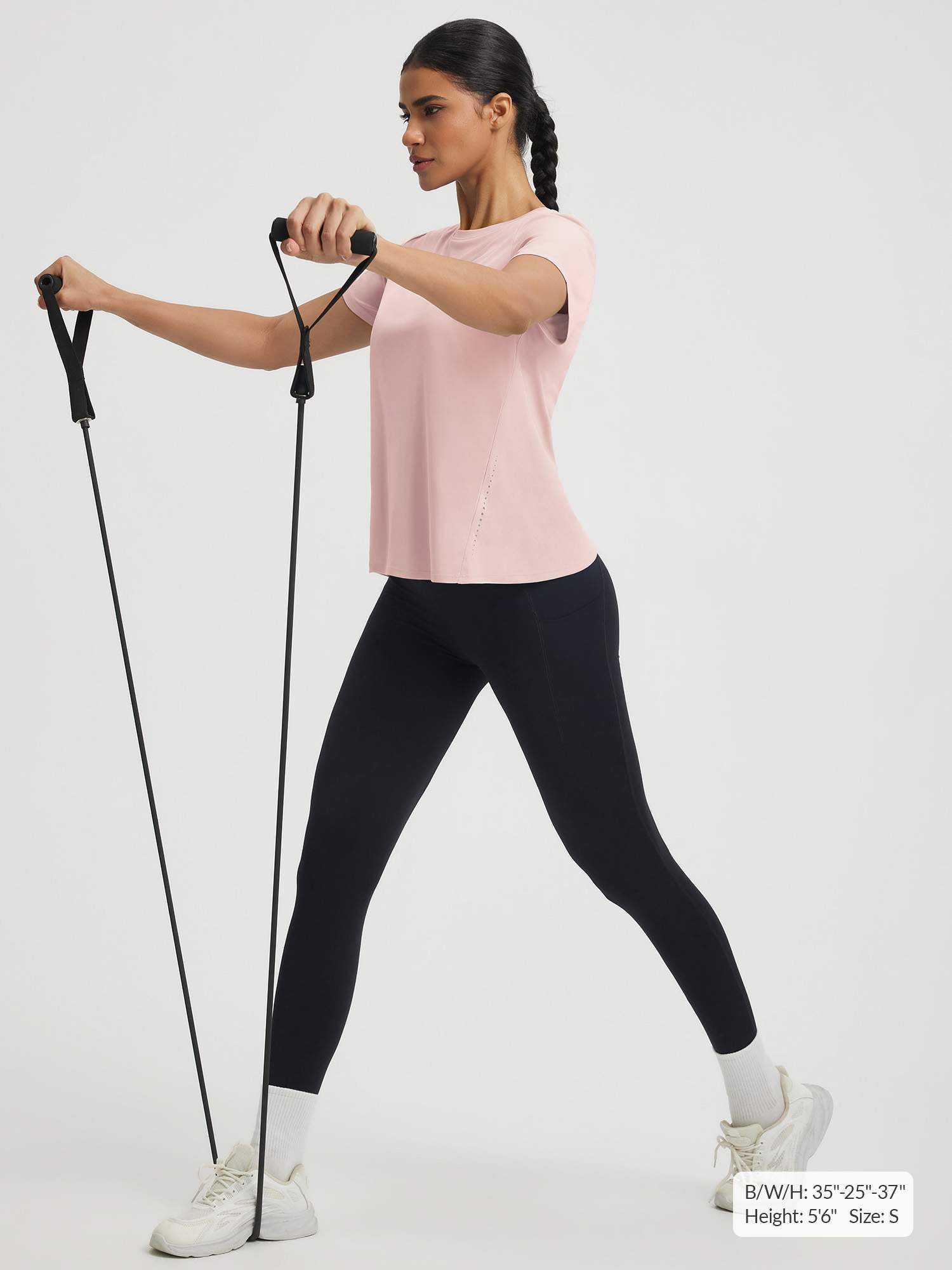 Quick dry pink short sleeve athletic top on woman doing resistance band workout. #color_Pink Dogwood