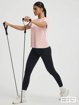 Quick dry pink short sleeve athletic top on woman doing resistance band workout. #color_Pink Dogwood