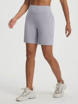 Woman wearing Baleaf high-rise stretchy running shorts in light grey, 7" inseam, with pockets. #color_Light Gray