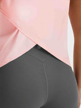 Baleaf pink UPF 50+ tank top with open back crossover detail worn with grey leggings. #color_Pink