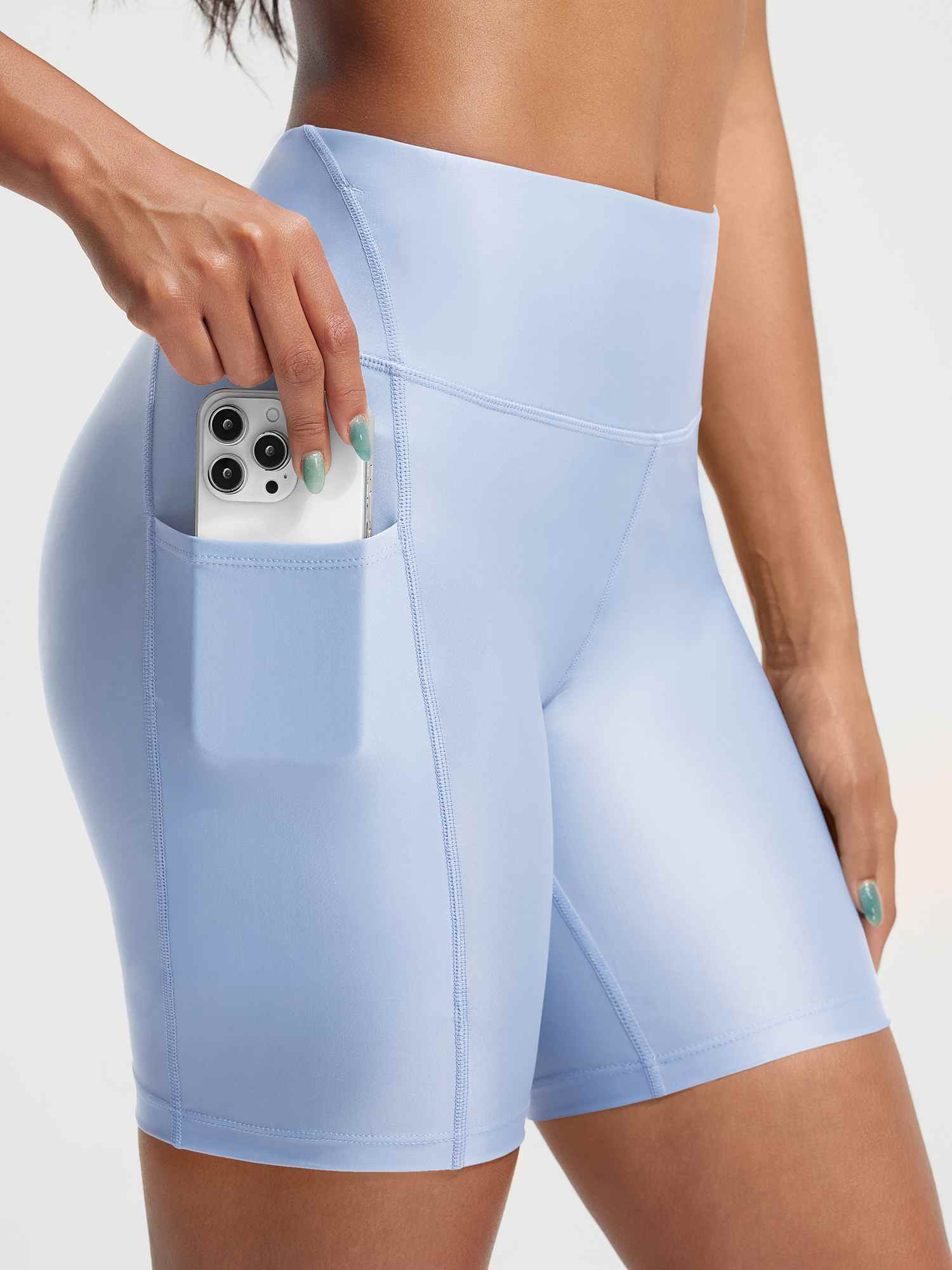 Baleaf light blue high-rise swim shorts with side pocket holding a smartphone. #color_Kentucky Blue