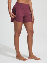 Baleaf women's maroon UPF 50+ board shorts with open zipper pocket detail.