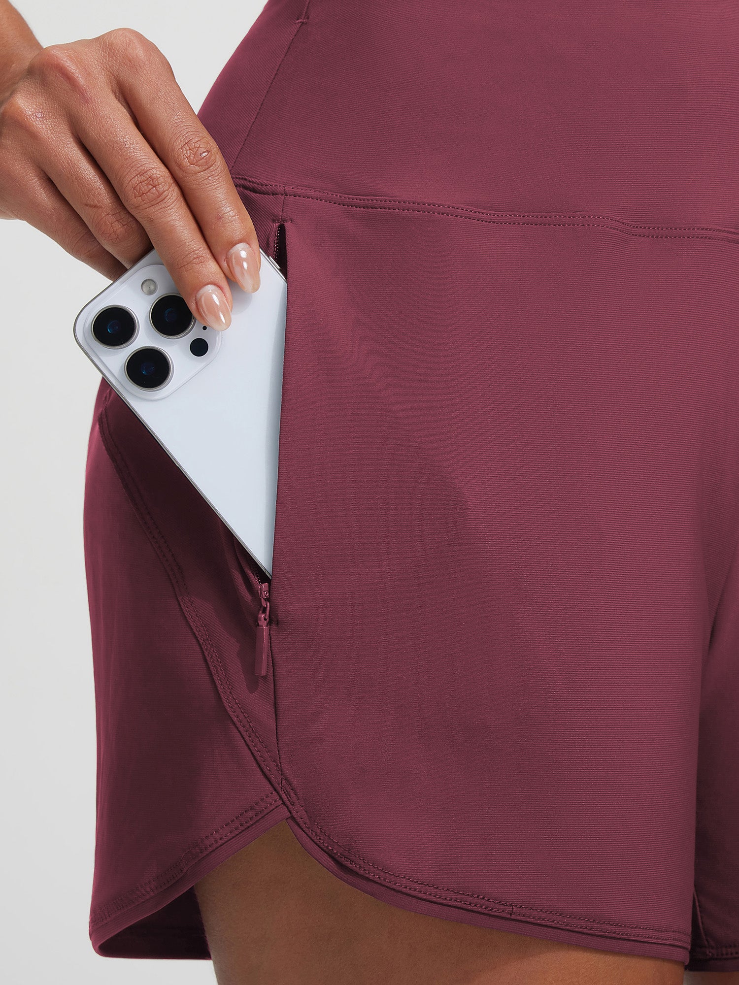 Baleaf maroon board short with phone in secure zipper pocket. UPF 50+