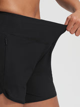 Baleaf black 7'' UPF 50+ high-rise board shorts featuring zipper pockets and stretch waist.