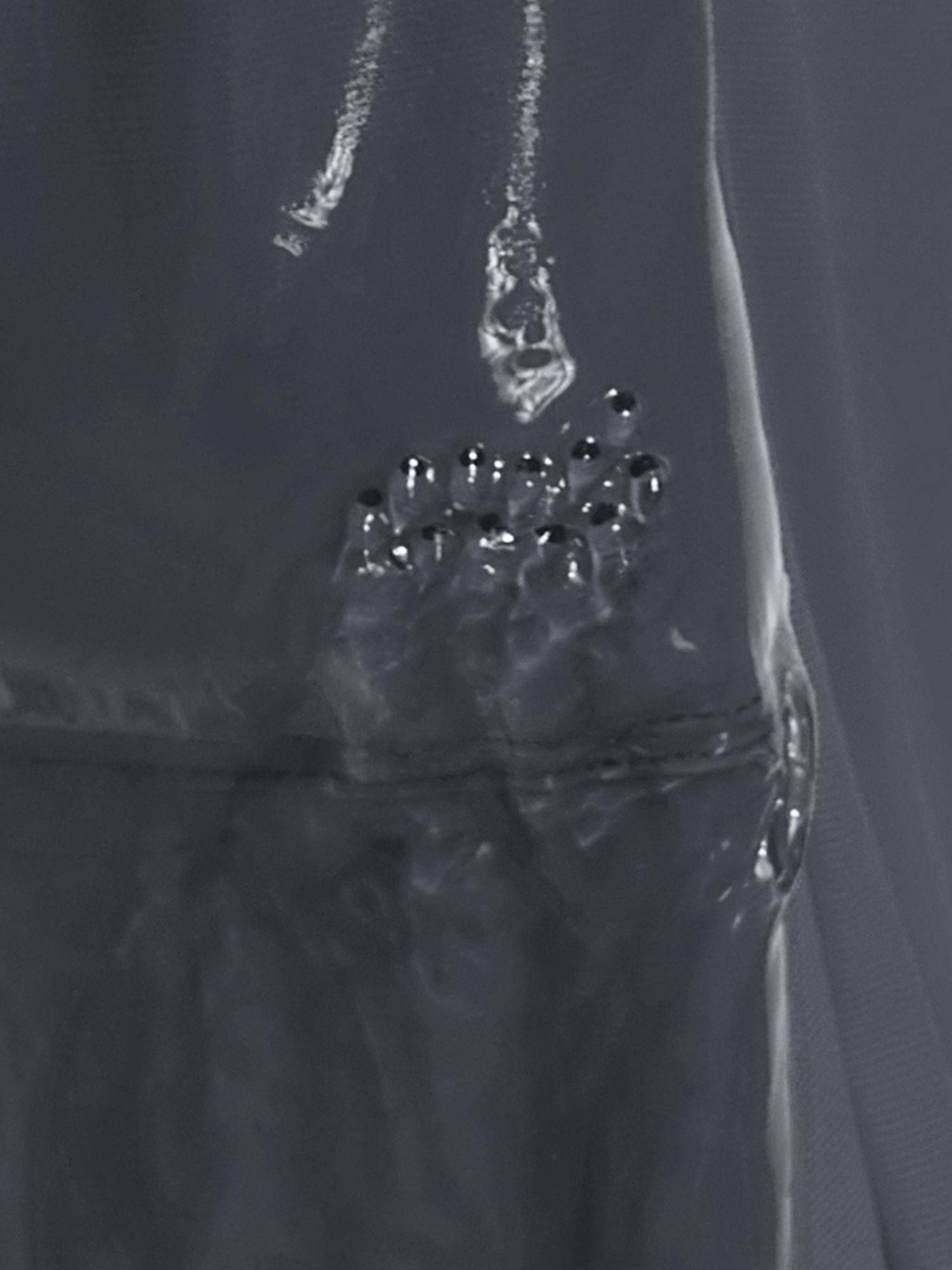 Baleaf UPF 50+ board shorts showing water exiting drainage holes. #color_Deep Gray