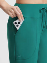 Baleaf dark green UPF 50+ high-rise board shorts: hand puts phone in pocket. #color_Teal Green