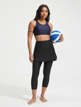 Baleaf UPF 50+ high-rise skirted swim pant 20" capri in black, worn by model holding volleyball. #color_Black