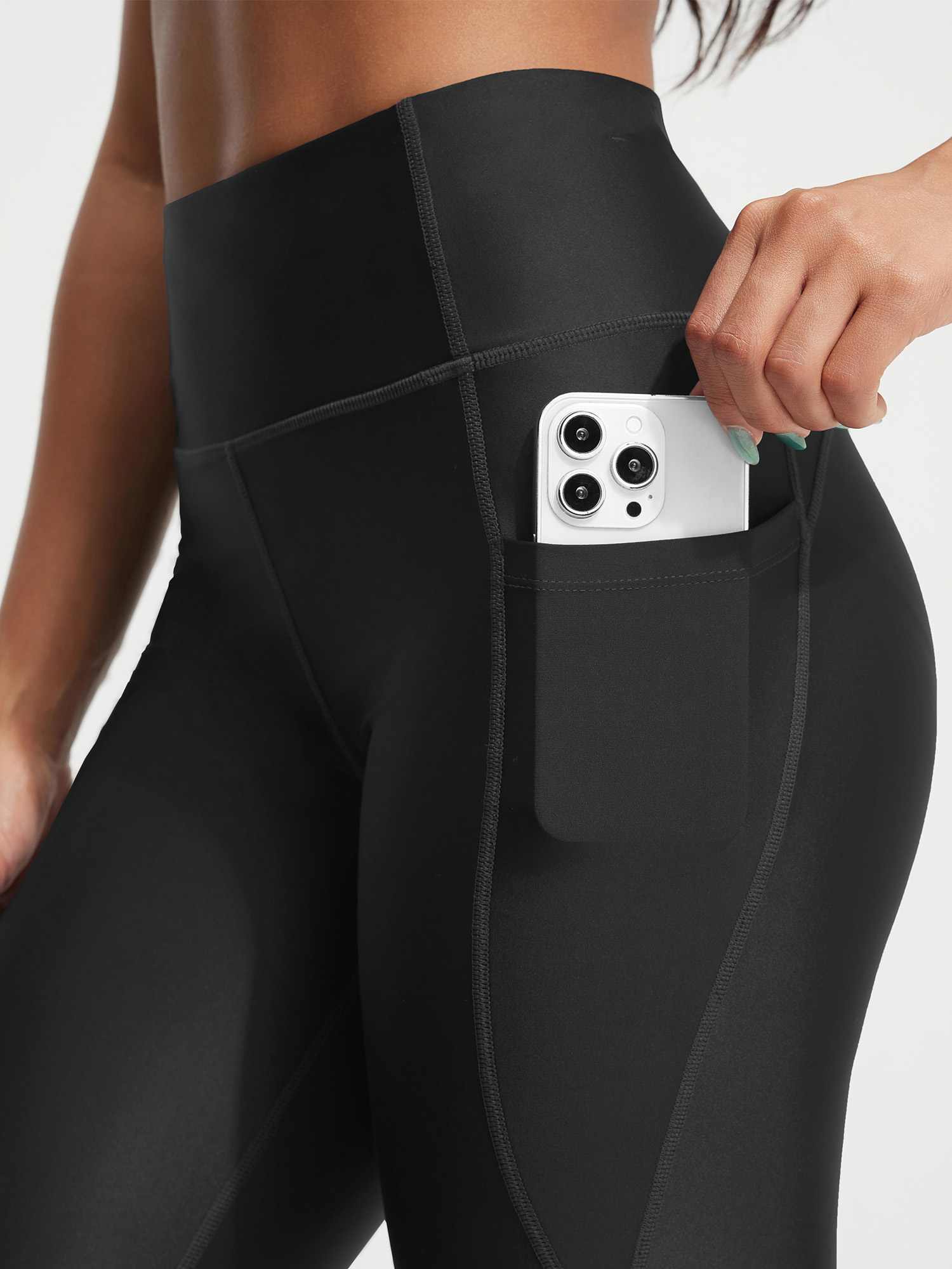 Black 18" UPF50+ high rise swim capris with side pocket holding smartphone. #color_Black