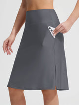 Grey Baleaf UPF 50+ swim skirt featuring slant side pockets, a phone is shown being placed inside one. #color_Dark Gray