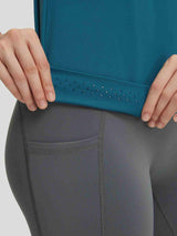 Baleaf teal crewneck workout tank top with dotted grip hem, shown with grey leggings. #color_Deep Blue