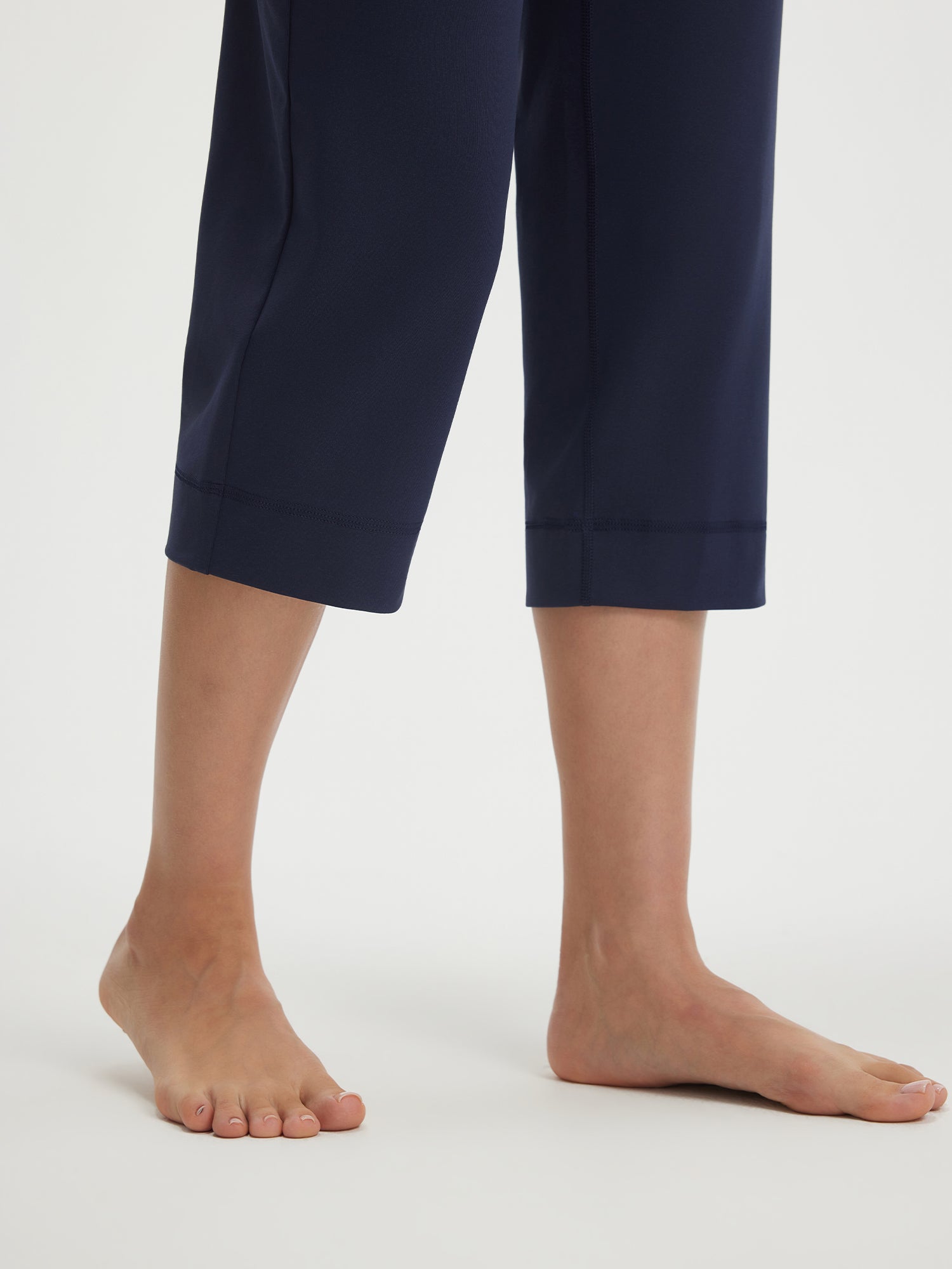 Baleaf navy blue stretchy high-rise capri pants 21-inch inseam with tapered hem #color_Navy