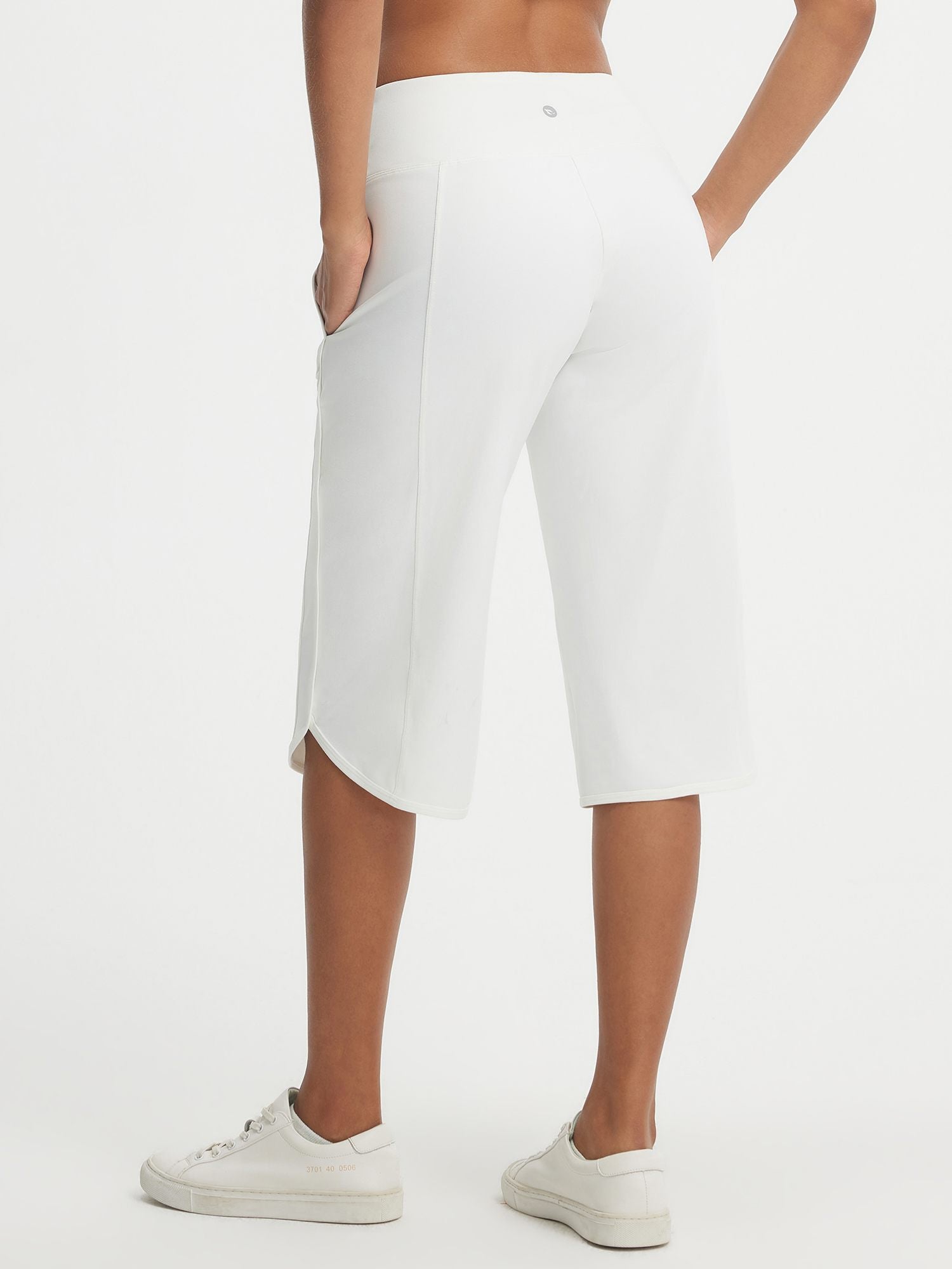 Baleaf white stretchy high-rise 17" capri pants with side pocket and curved split hem. #color_White