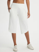 White Baleaf high-rise 17-inch capri pants with side pockets and split hem. #color_White