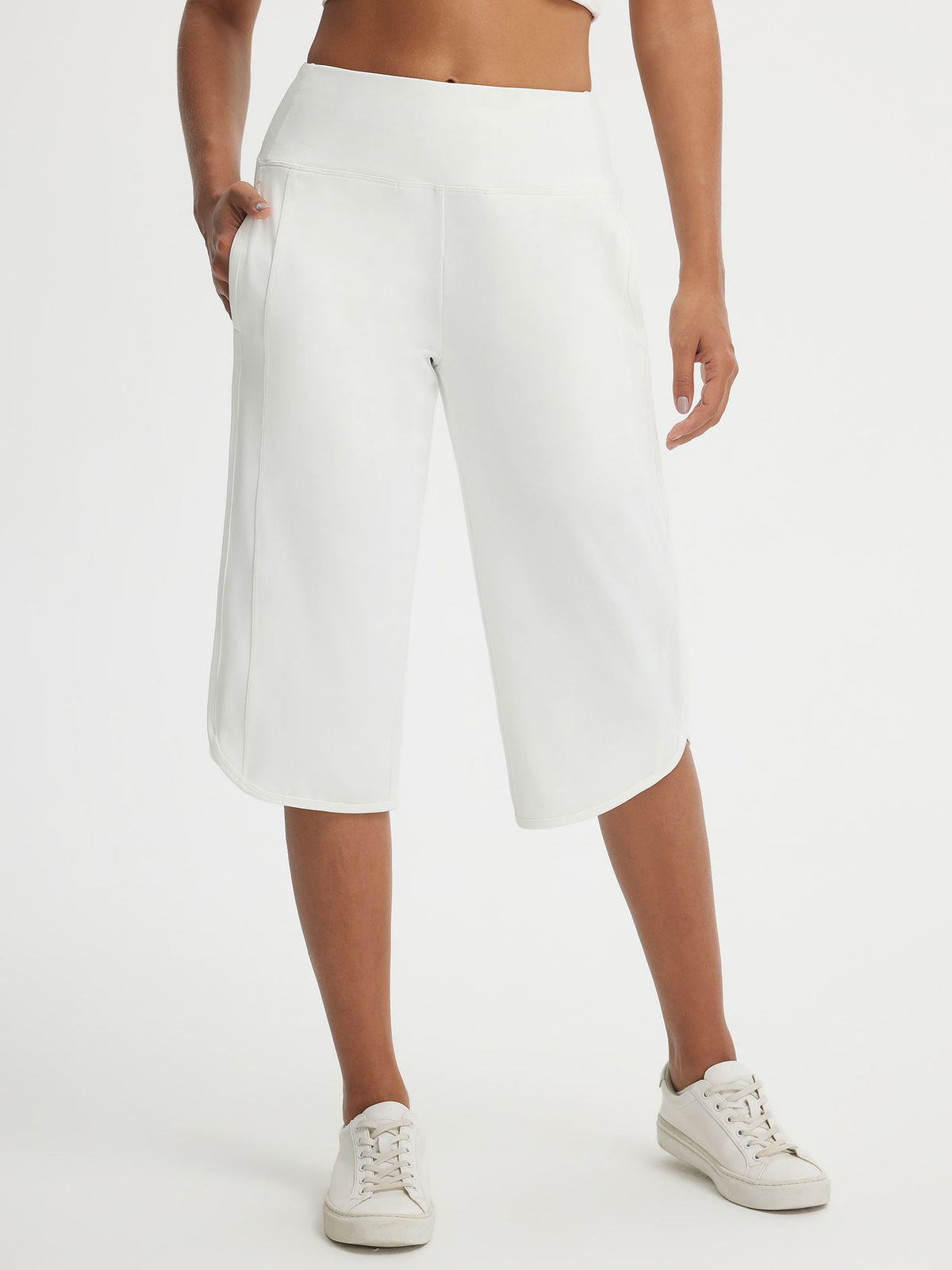 White Baleaf high-rise 17-inch capri pants with side pockets and split hem. #color_White