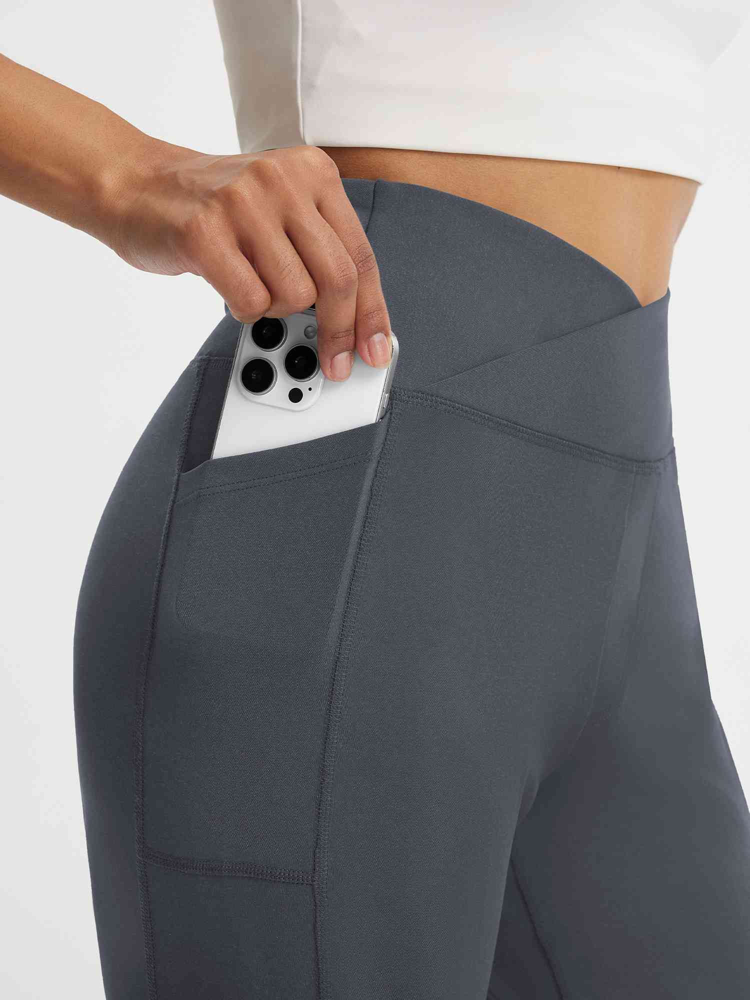 Baleaf grey V-waist 9" Bermuda shorts with deep side pocket holding smartphone. #color_Dark Gray