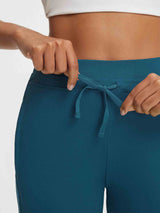 Baleaf ultra-soft high-rise teal 25" pants showing adjustable drawstring waistband tied #color_Deep Blue