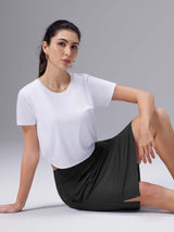 Black Laureate UPF50+ knee-length skort with split hem, designed for active wear. #color_Black