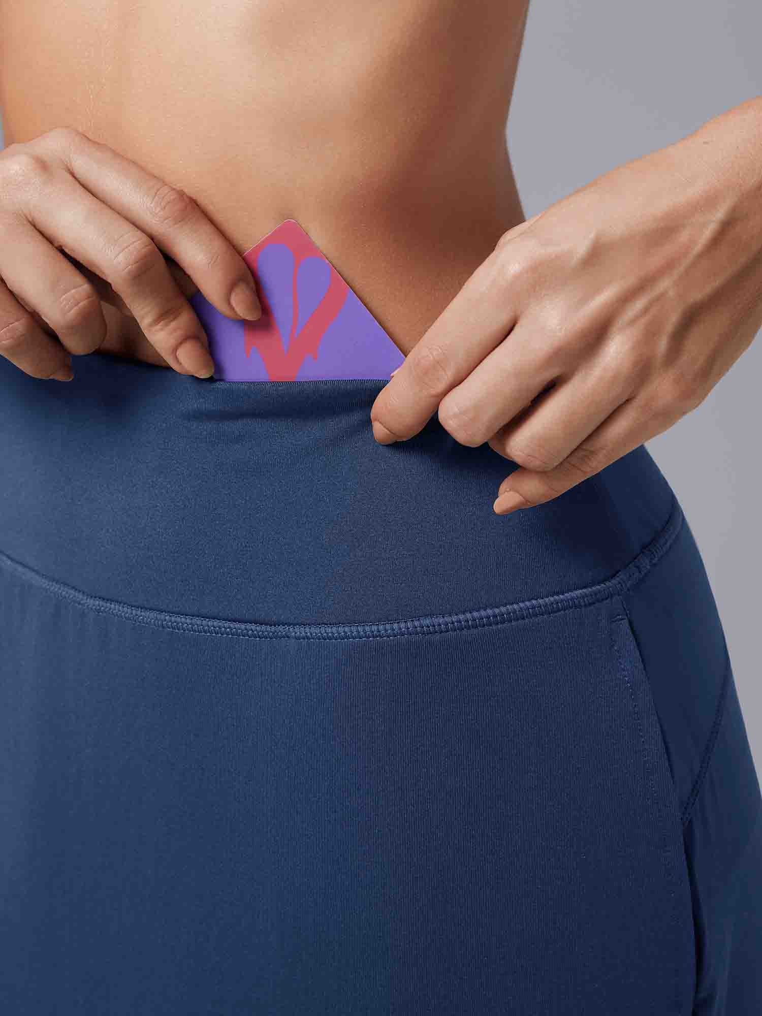 Blue Laureate UPF50+ knee-length skort with hidden waistband pocket detail. #color_ Peacoat