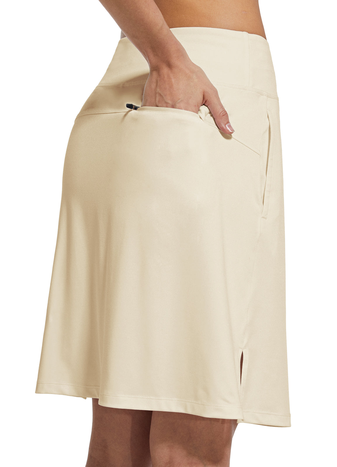 Cream UPF 50+ women's skort with zippered pocket, ideal for golf and tennis.