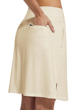 Cream UPF 50+ women's skort with zippered pocket, ideal for golf and tennis.