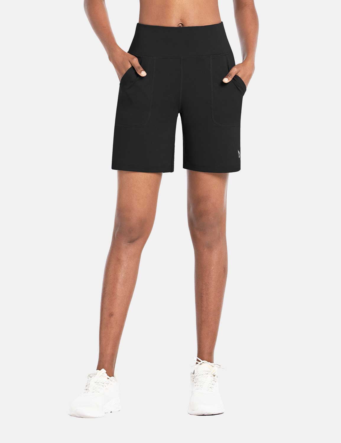 Black Laureate 3-Pocket Athletic Shorts with a high waist and side pockets, worn by a woman. #color_Black