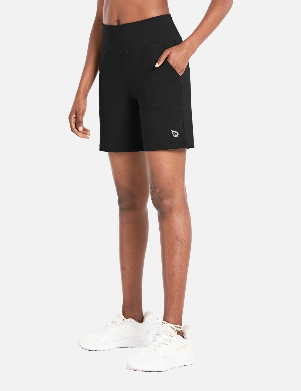 Black Laureate 3-Pocket Athletic Shorts with a high rise waistband and white sneakers. #color_Black