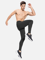 Men's black fleece-lined water-resistant running tights with ankle zippers #color_Black