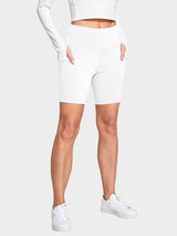 White women's high-waisted biker shorts with deep side pockets #color_White