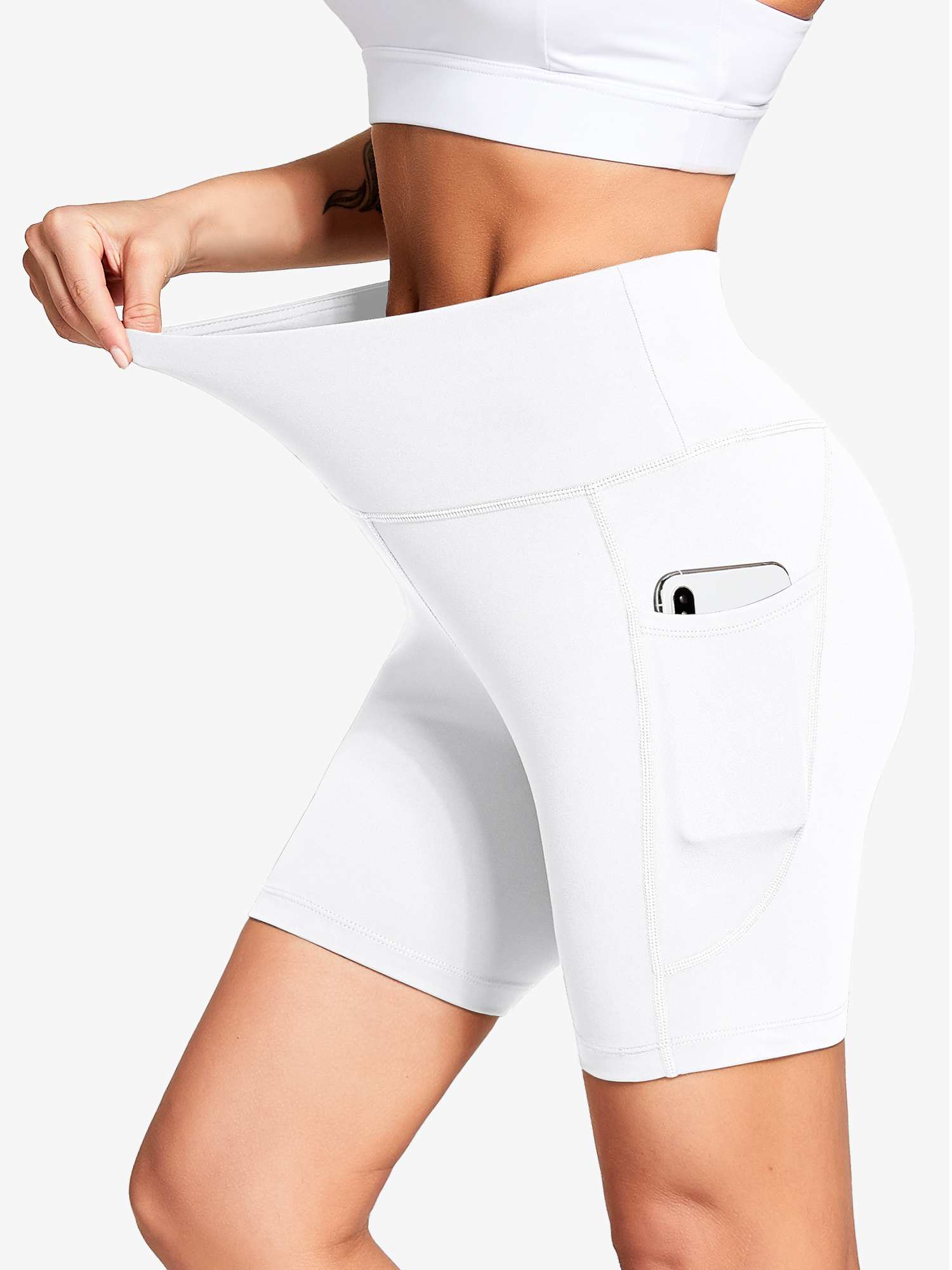 Women's white high-waisted biker shorts with deep side pockets and stretch fabric. #color_White