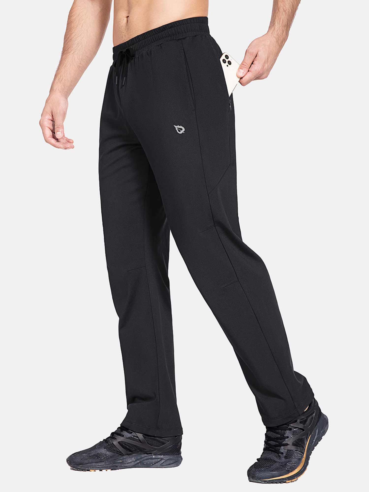Man putting smartphone in side zipper pocket of Baleaf black fleece lined water resistant pants