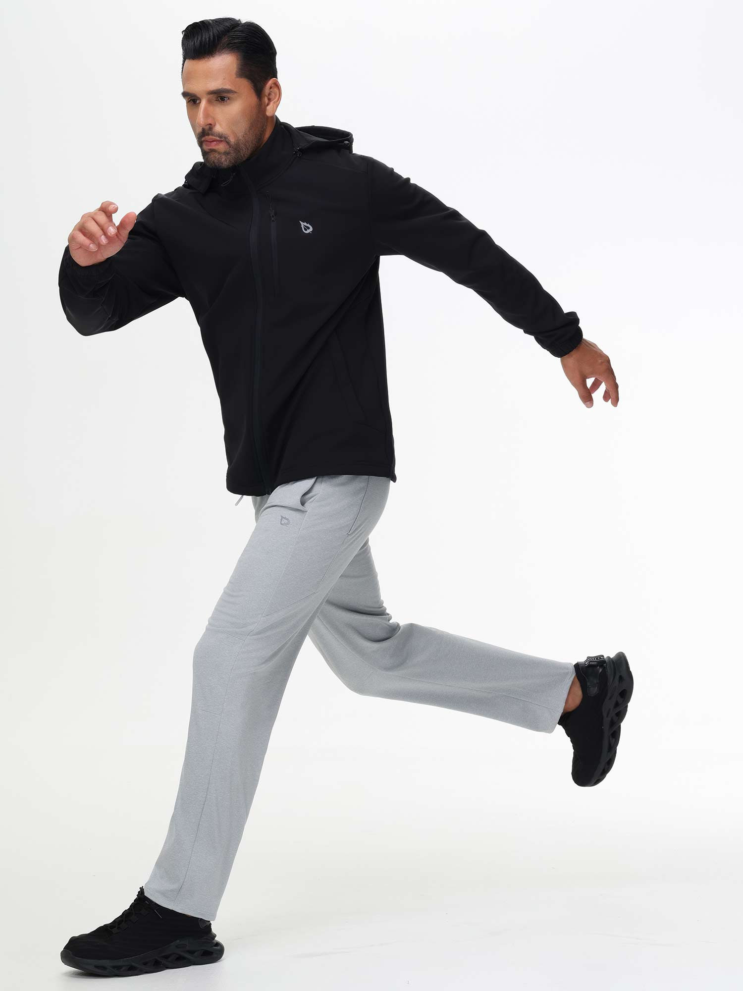 Athletic man running in light gray Baleaf fleece lined pants and black jacket