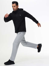 Athletic man running in light gray Baleaf fleece lined pants and black jacket
