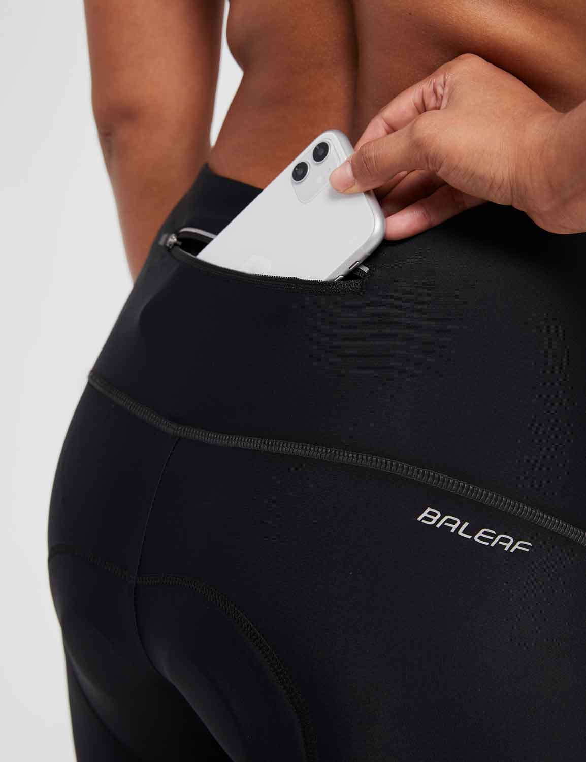 Women's black BALEAF padded cycling capris featuring a zippered phone pocket. #color_Black